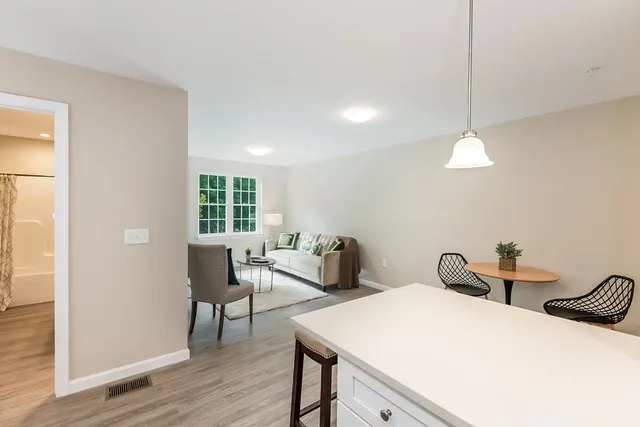 a view of a room with wooden floor and windows
