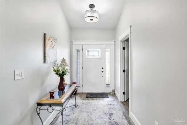 a kitchen with granite countertop a stove refrigerator and microwave
