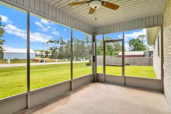 a view of an empty room with large windows