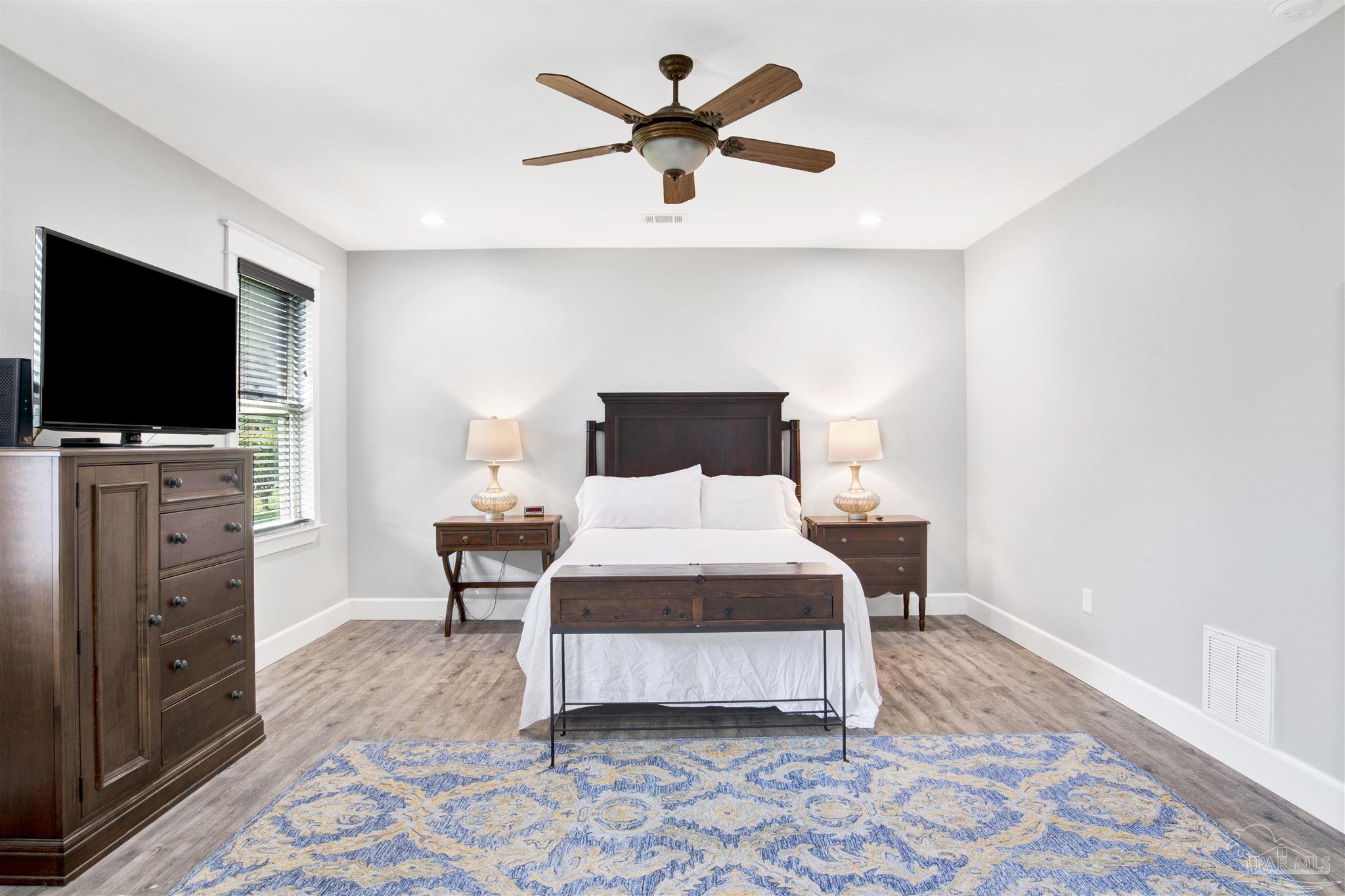 2549 Santa Rosa Drive Lillian, AL 36549 - Photo 18 of 53 a bedroom with a bed and a flat screen tv