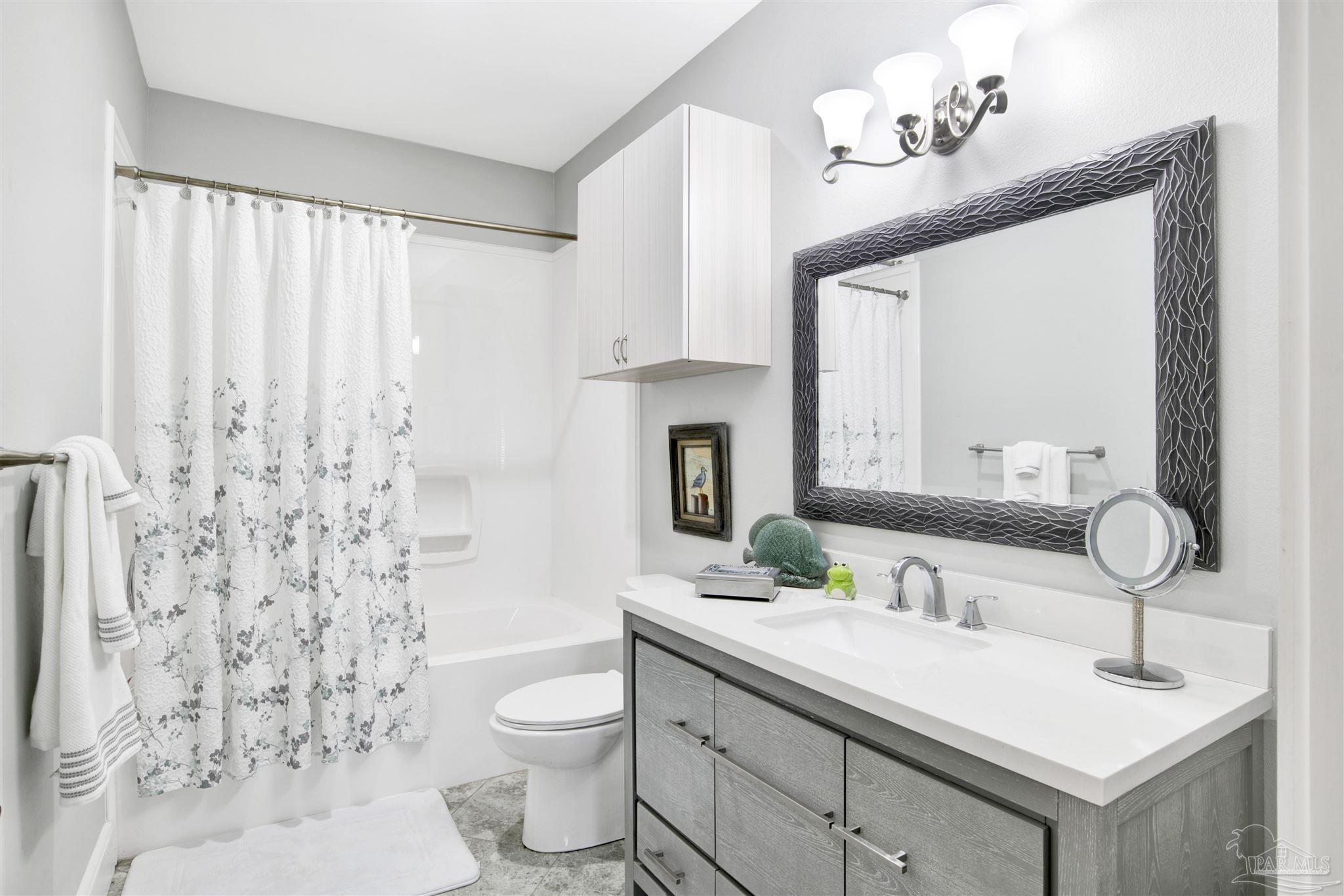 2549 Santa Rosa Drive Lillian, AL 36549 - Photo 22 of 53 a bathroom with a sink vanity mirror and toilet