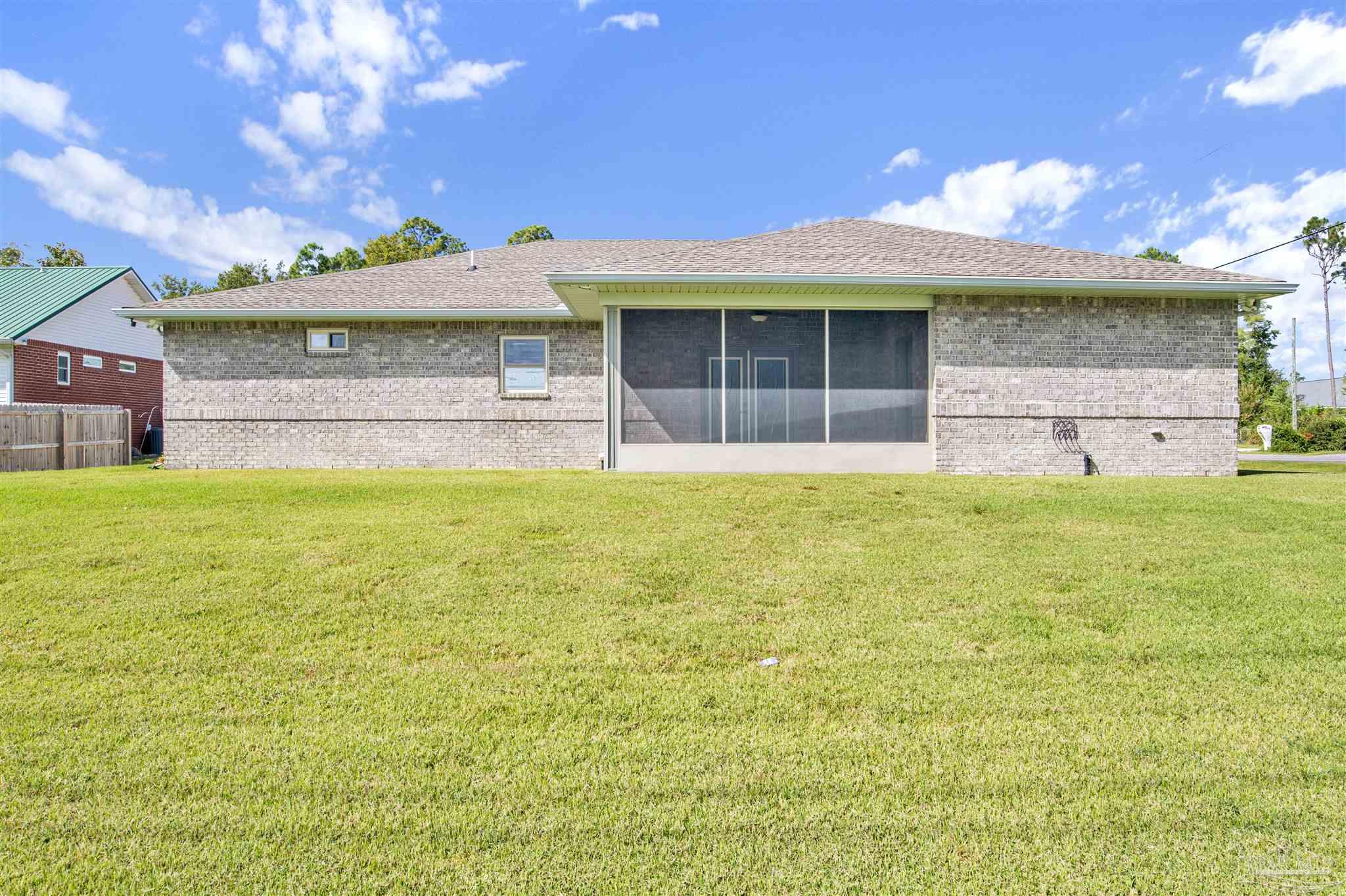 2549 Santa Rosa Drive Lillian, AL 36549 - Photo 29 of 53 a front view of a house with a garden and yard