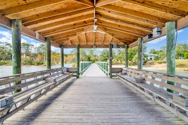 a view of a balcony with wooden floor and fence