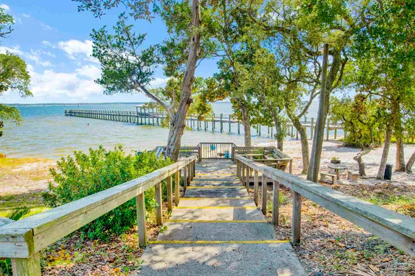 an aerial view of a house with swimming pool and ocean view