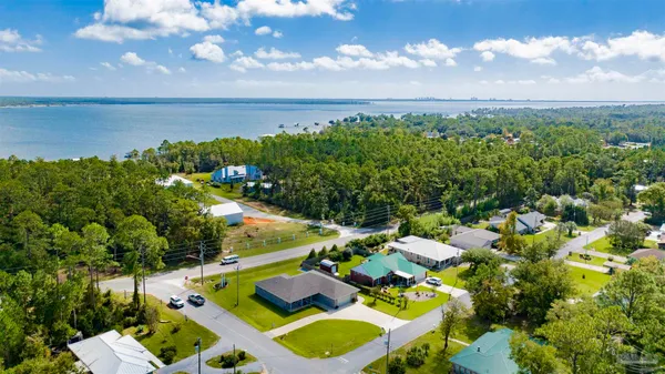 a front view of a house with swimming pool having outdoor seating