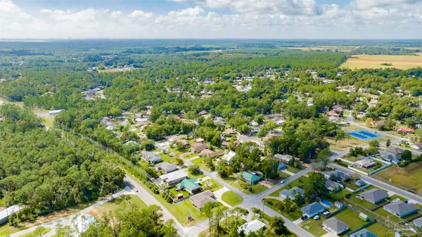 a view of a backyard with a tree