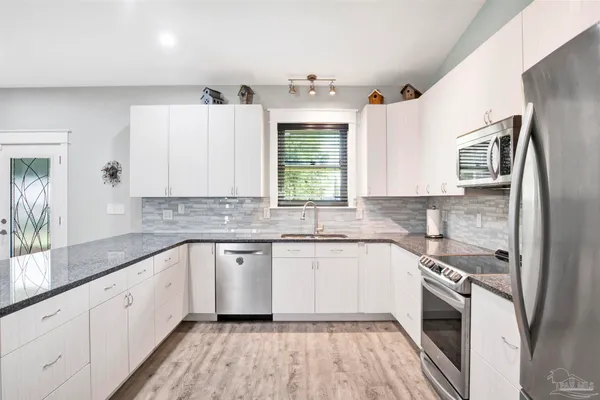 a kitchen with a sink stove and refrigerator