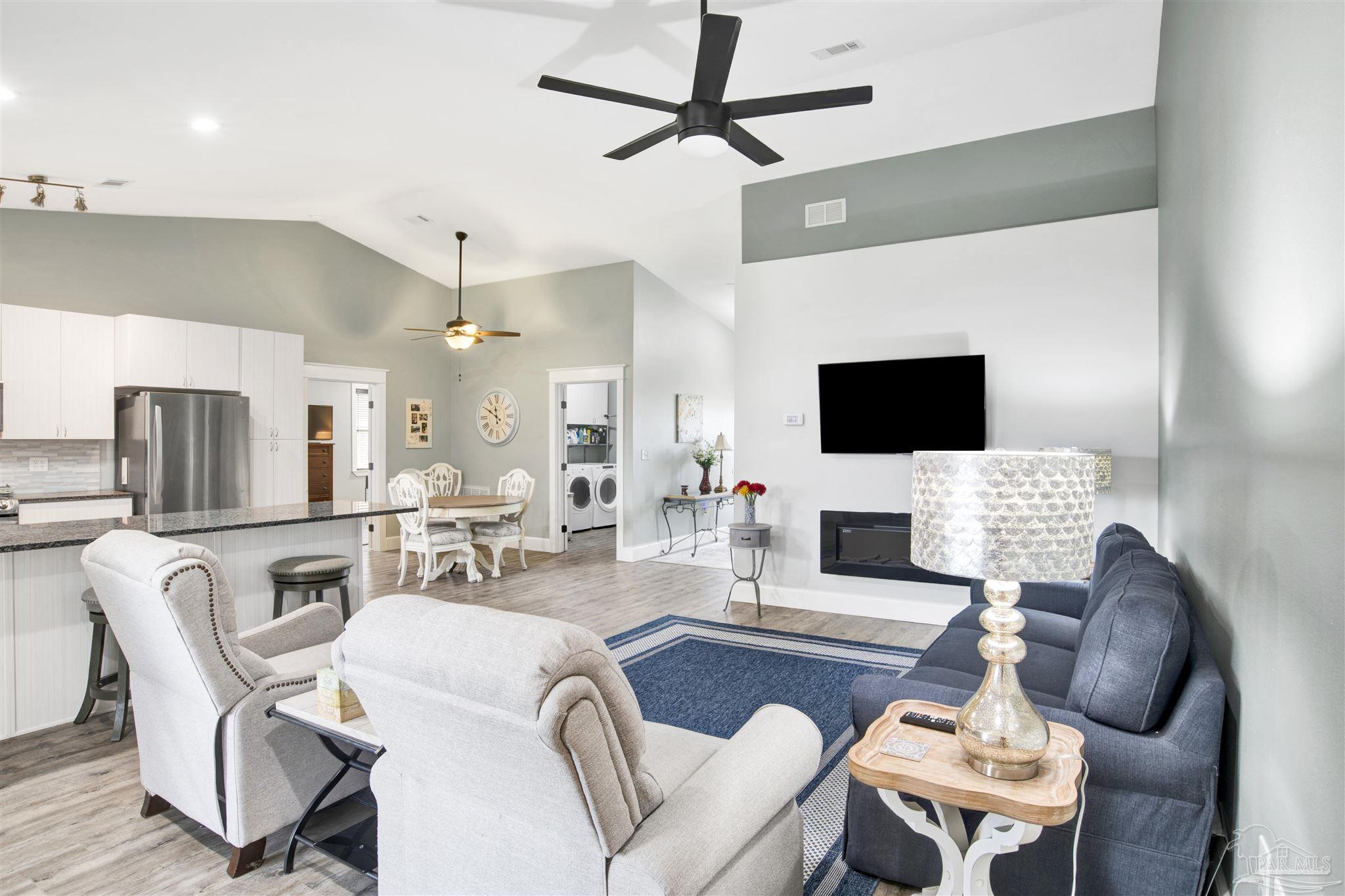 2549 Santa Rosa Drive Lillian, AL 36549 - Photo 6 of 53 a living room with furniture a flat screen tv and kitchen view