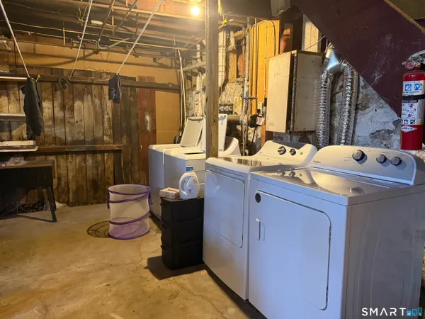 a room with two washing machine and sink