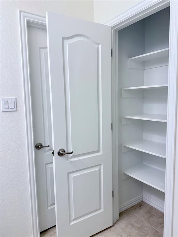 1336 Morning View Road Georgetown, TX 78628 - Photo 32 of 40 Ample built-in shelving offers smart storage solutions within this practical pantry.