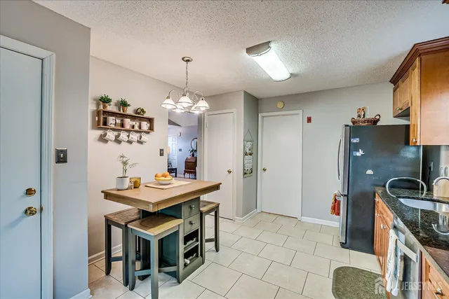 a kitchen that has a table and a stove in it
