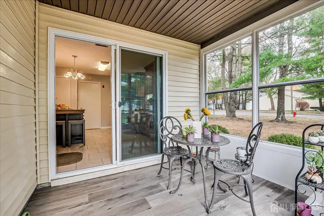 a dining room with furniture and front door