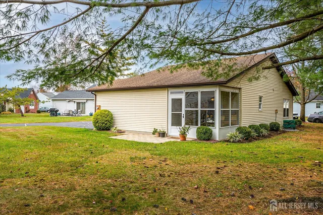 a view of a house with a yard and sitting area