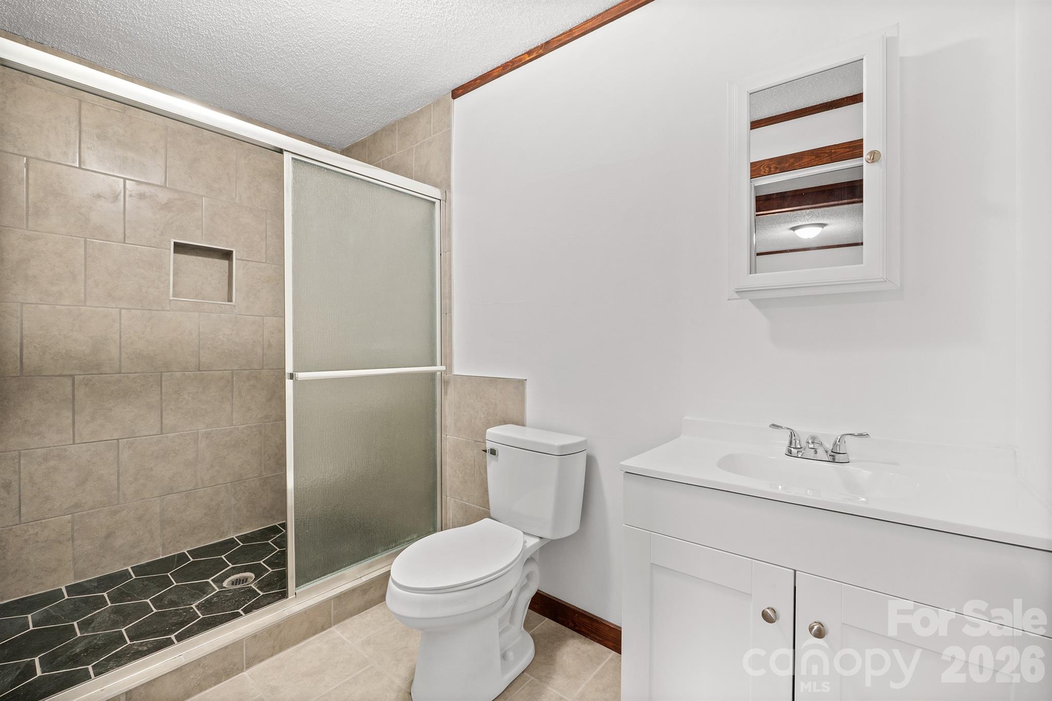 7400 Corn Hill Road Connelly Springs, NC 28612 - Photo 23 of 41 a bathroom with a toilet sink and shower