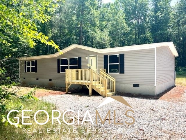 1616 Crumps Bridge Road Martin, GA 30557 - Photo 1 of 1 a front view of a house with a yard and garage
