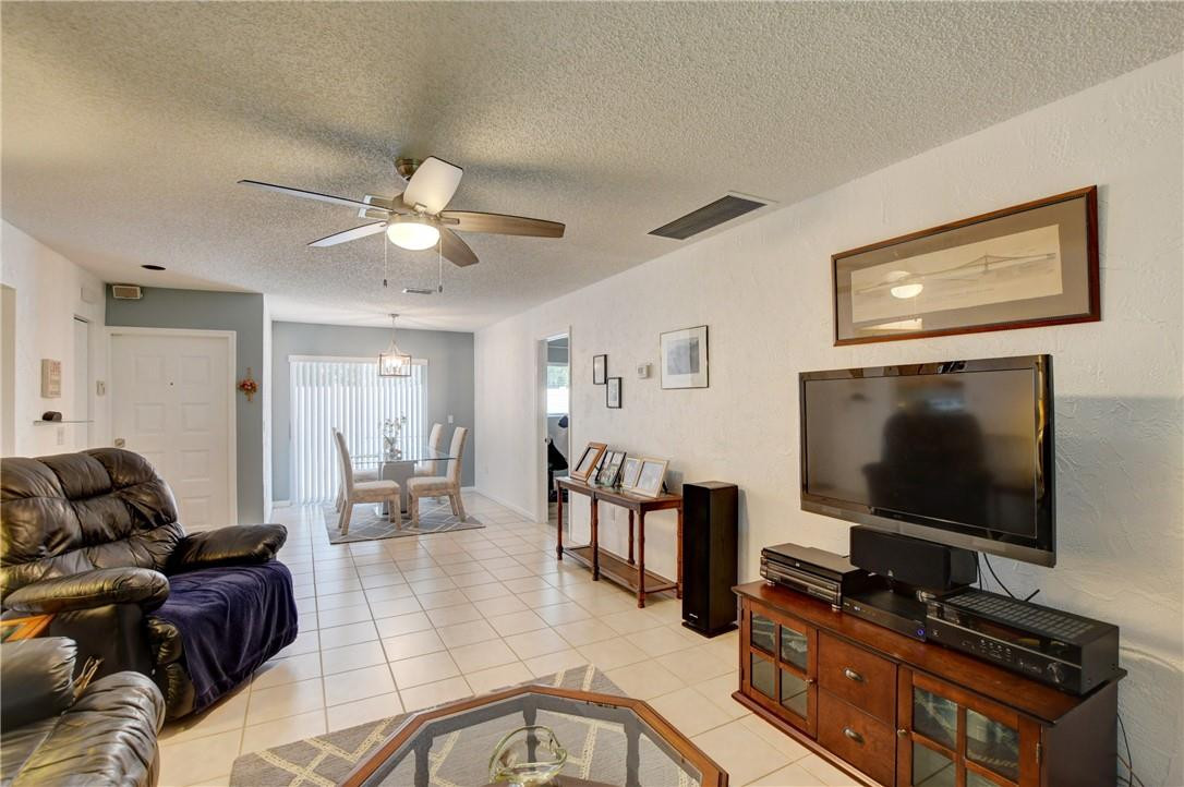 9285 Southwest 5th Street, Unit C Boca Raton, FL 33428 - Photo 19 of 31 a living room with furniture and a flat screen tv