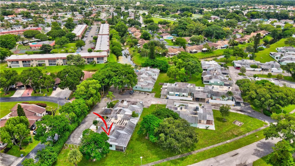 9285 Southwest 5th Street, Unit C Boca Raton, FL 33428 - Photo 2 of 31 an aerial view of residential houses with outdoor space and trees all around
