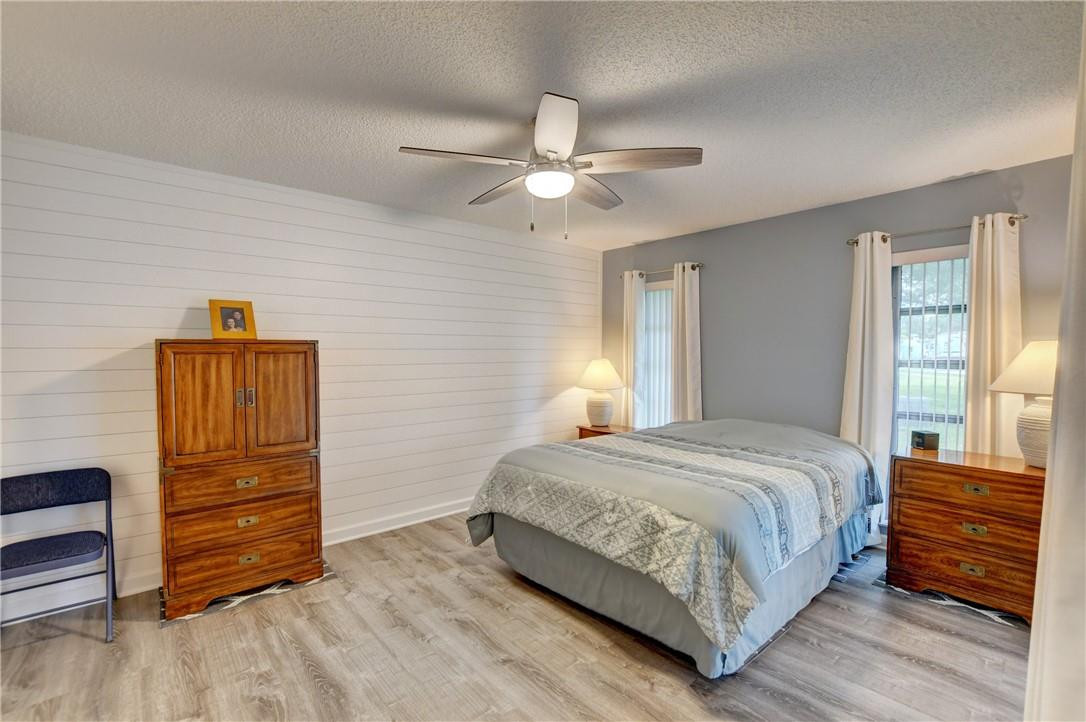 9285 Southwest 5th Street, Unit C Boca Raton, FL 33428 - Photo 25 of 31 a bedroom with a bed and furniture
