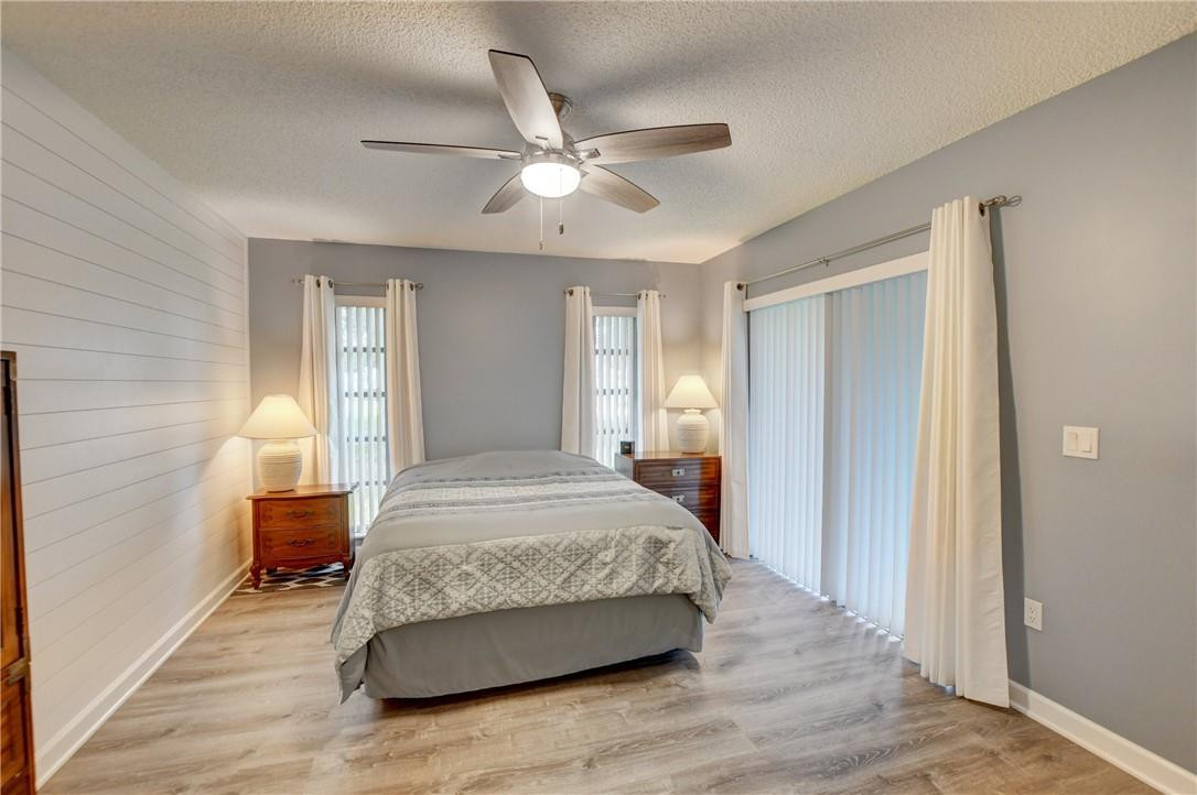 9285 Southwest 5th Street, Unit C Boca Raton, FL 33428 - Photo 26 of 31 a spacious bedroom with a bed and wooden floor
