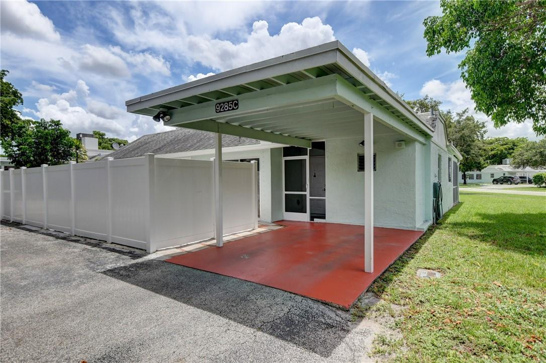 9285 Southwest 5th Street, Unit C Boca Raton, FL 33428 - Photo 4 of 31 a front view of house with yard