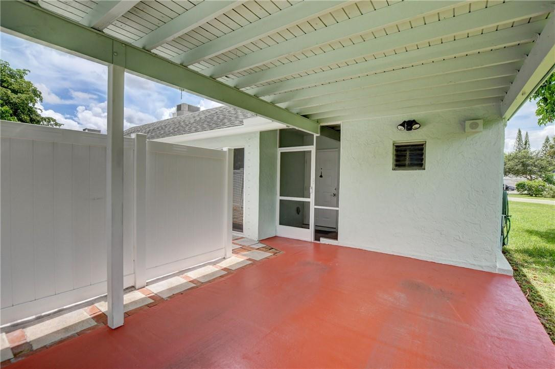 9285 Southwest 5th Street, Unit C Boca Raton, FL 33428 - Photo 6 of 31 an empty room with windows and garden view