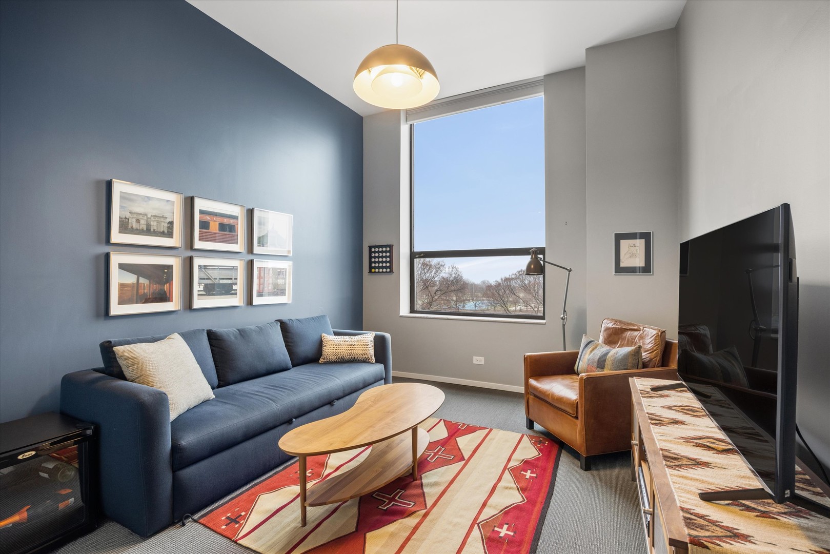 910 South Michigan Avenue, Unit 501 Chicago, IL 60605 - Photo 12 of 21 a living room with furniture a flat screen tv and a window