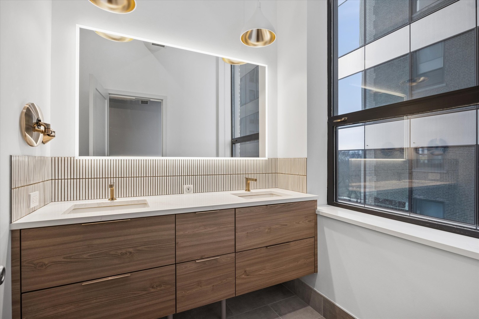 910 South Michigan Avenue, Unit 501 Chicago, IL 60605 - Photo 18 of 21 a bathroom with a double vanity sink and mirror