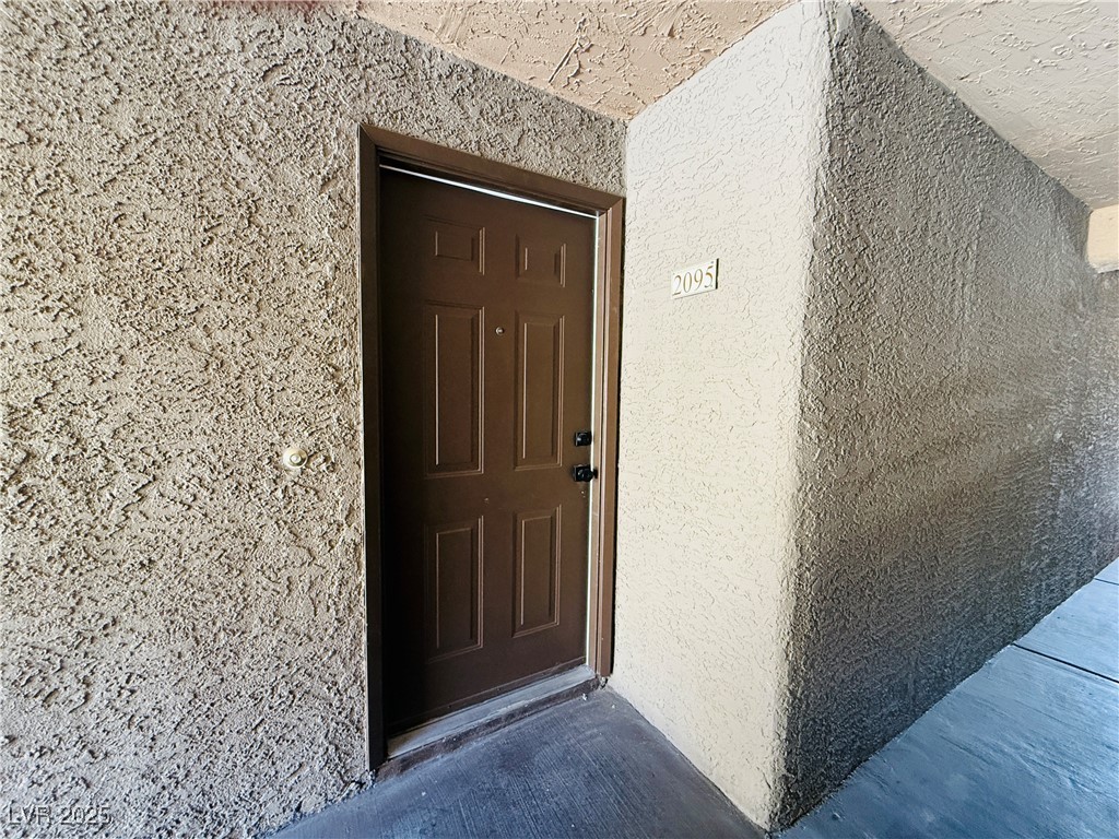 2200 South Fort Apache Road, Unit 2095 Las Vegas, NV 89117 - Photo 3 of 16 Doorway to property with stucco siding
