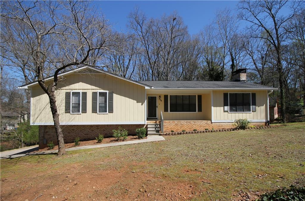 336 Princess Avenue Woodstock, GA 30189 - Photo 1 of 1 a front view of a house with a yard covered with snow in front of house