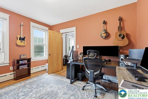 2021 Leithsville Road Hellertown, PA 18055 - Photo 17 of 39 Main level bedroom used as a spacious office showcases the versatile spaces crafted throughout this home.