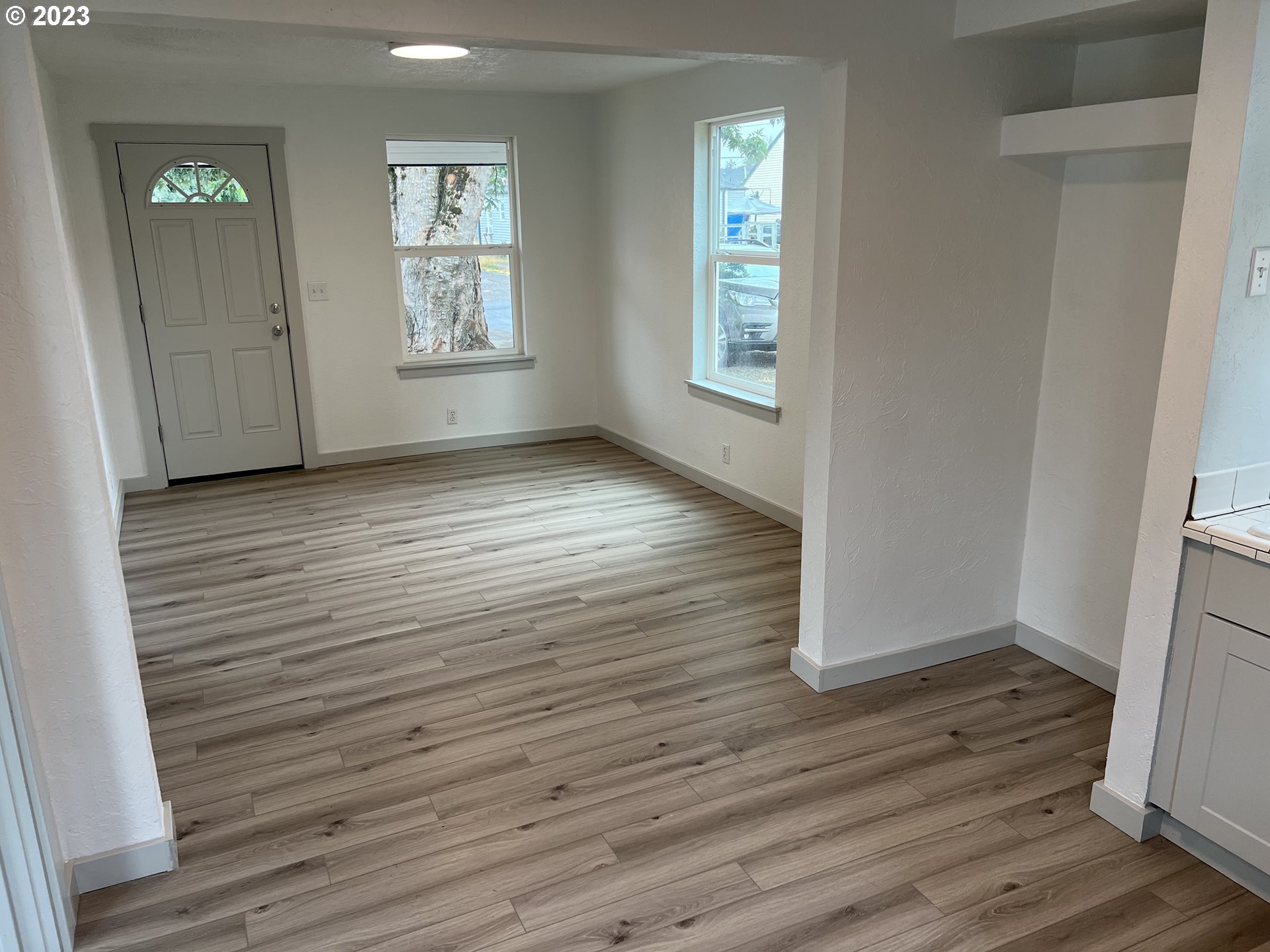 365 North 24th Street Springfield, OR 97477 - Photo 2 of 14 an empty room with wooden floor and windows