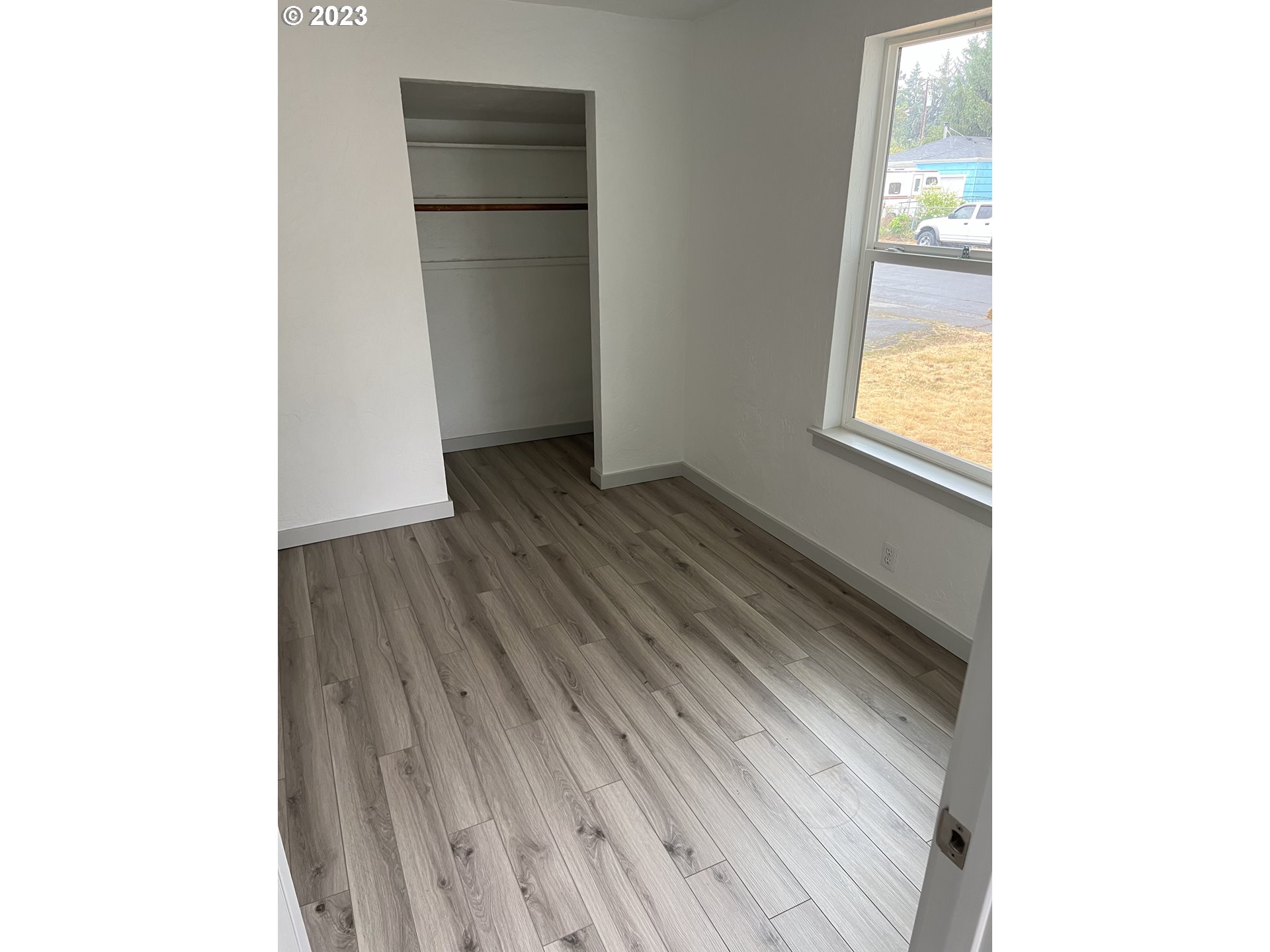 365 North 24th Street Springfield, OR 97477 - Photo 7 of 14 a view of an empty room with wooden floor and a window