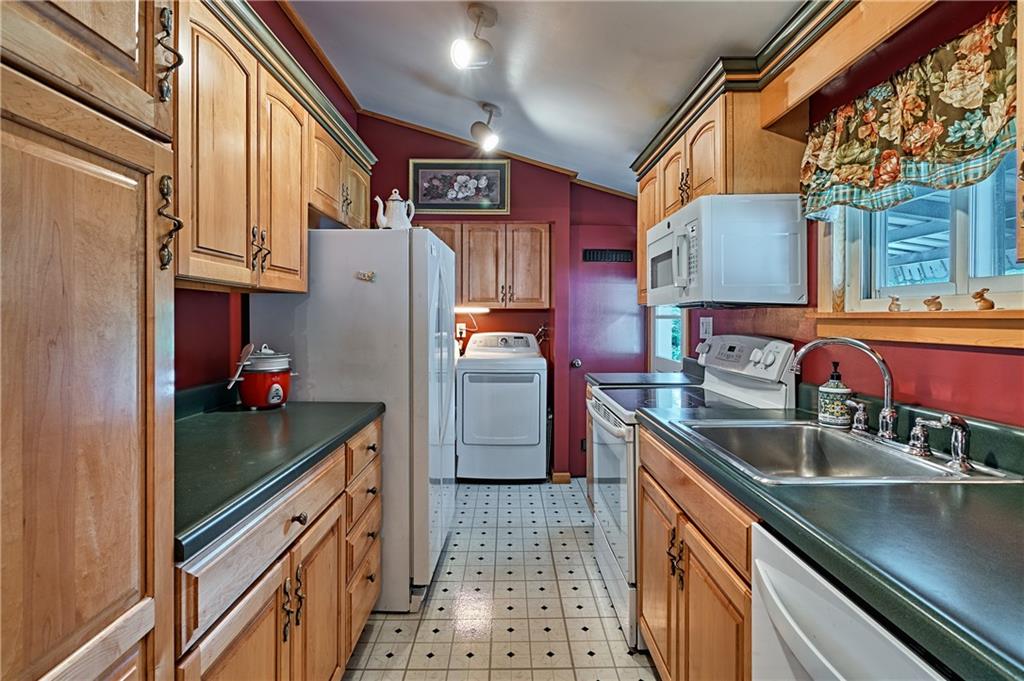 218 Evergreen Mill Road Harmony, PA 16037 - Photo 17 of 25 a kitchen with stainless steel appliances granite countertop a refrigerator and a sink