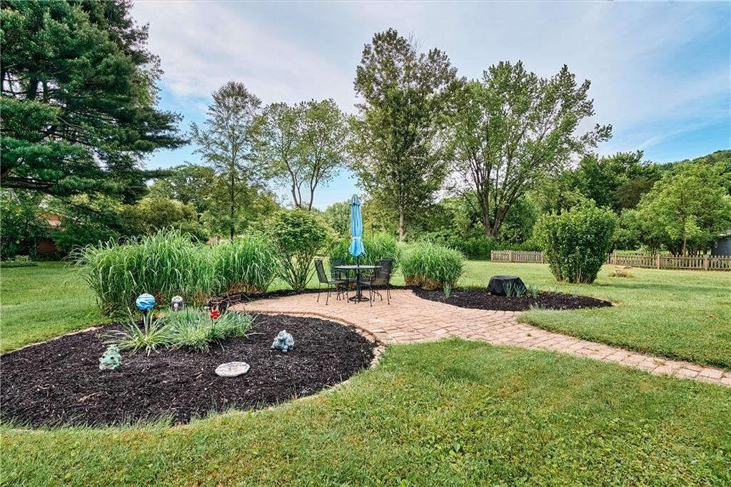 218 Evergreen Mill Road Harmony, PA 16037 - Photo 2 of 25 a view of a backyard with table and chairs plants and trees