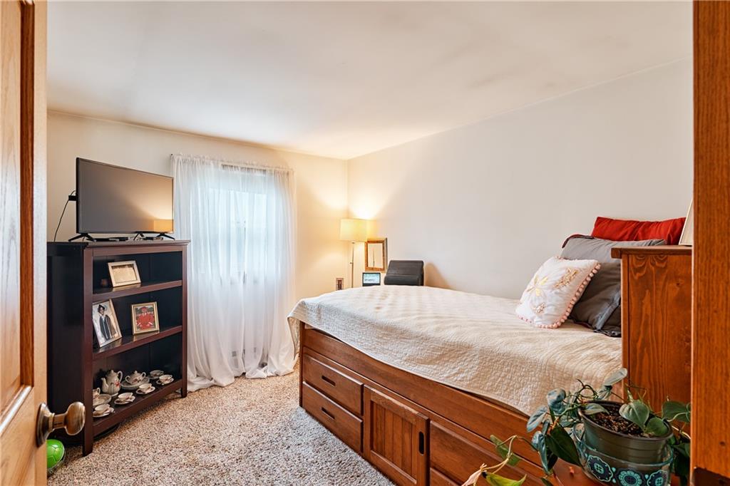 218 Evergreen Mill Road Harmony, PA 16037 - Photo 22 of 25 a bedroom with a bed and a flat screen tv