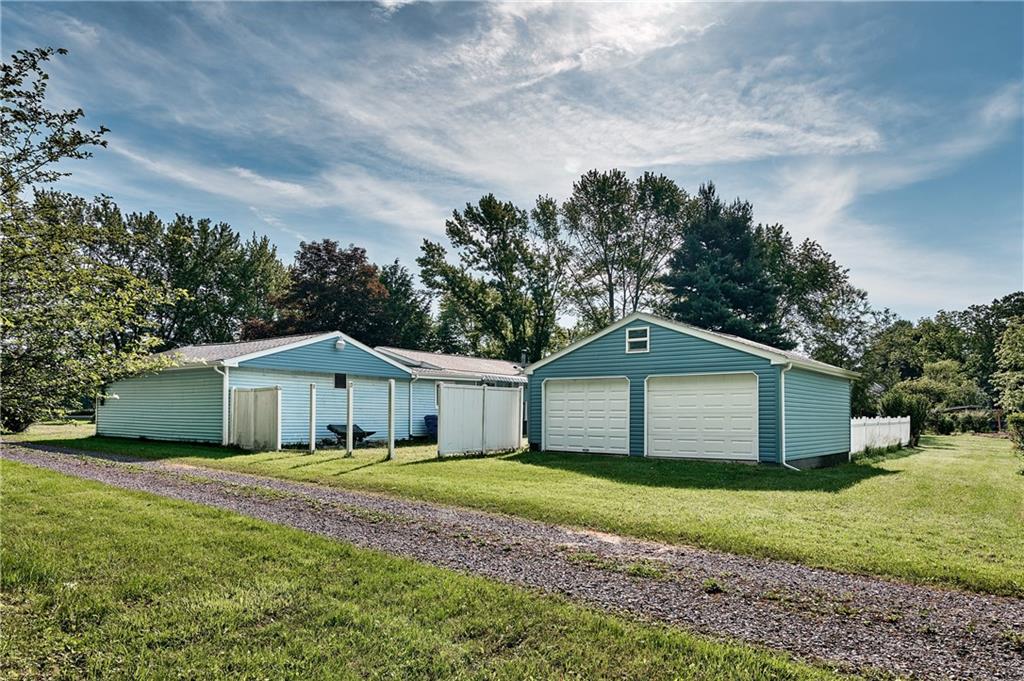 218 Evergreen Mill Road Harmony, PA 16037 - Photo 3 of 25 a front view of a house with a garden and yard