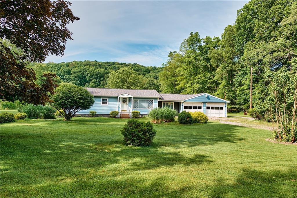 218 Evergreen Mill Road Harmony, PA 16037 - Photo 8 of 25 a front view of a house with a yard table and chairs
