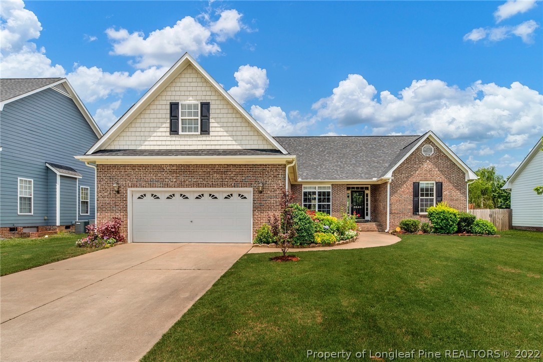 3540 Talus Road Fayetteville, NC 28306 - Photo 1 of 28 a front view of a house with a yard and garage