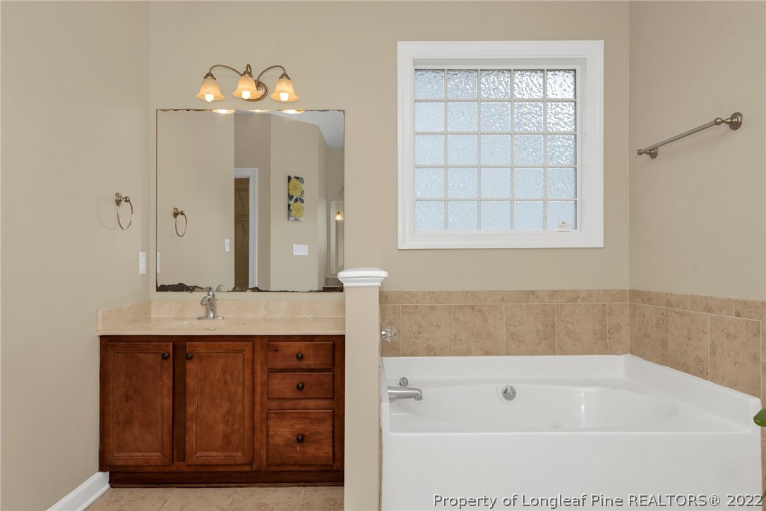 3540 Talus Road Fayetteville, NC 28306 - Photo 15 of 28 a bathroom with a tub sink and mirror