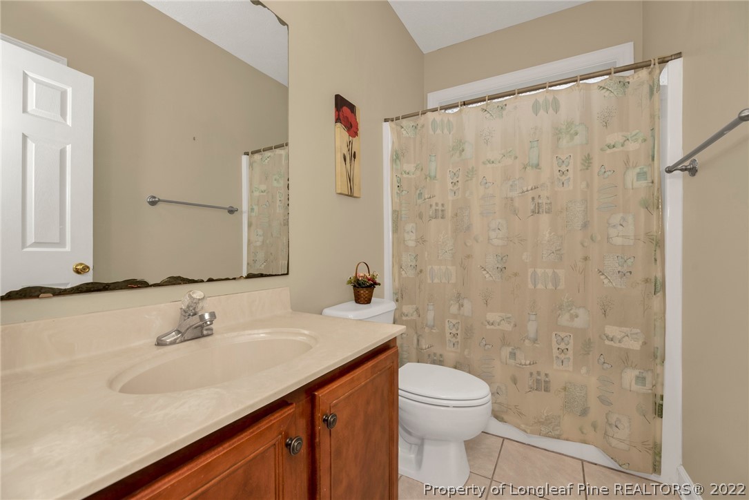 3540 Talus Road Fayetteville, NC 28306 - Photo 19 of 28 a bathroom with a sink toilet and shower