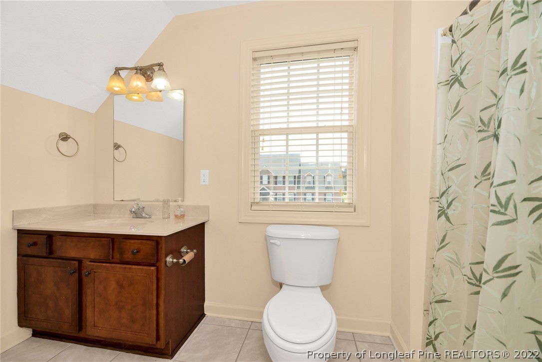 3540 Talus Road Fayetteville, NC 28306 - Photo 22 of 28 a bathroom with a toilet sink and mirror