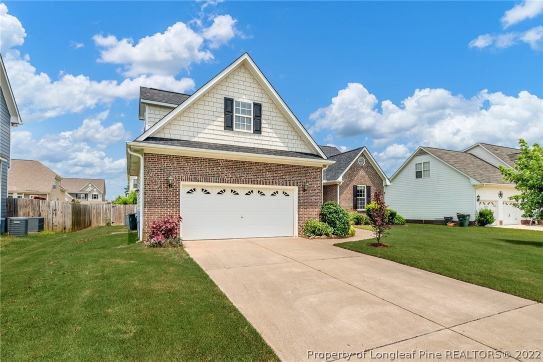 3540 Talus Road Fayetteville, NC 28306 - Photo 28 of 28 a front view of a house with a yard and garage