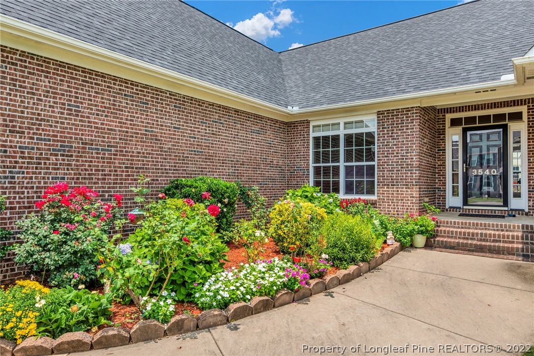 3540 Talus Road Fayetteville, NC 28306 - Photo 3 of 28 a flower garden is sitting in front of a house