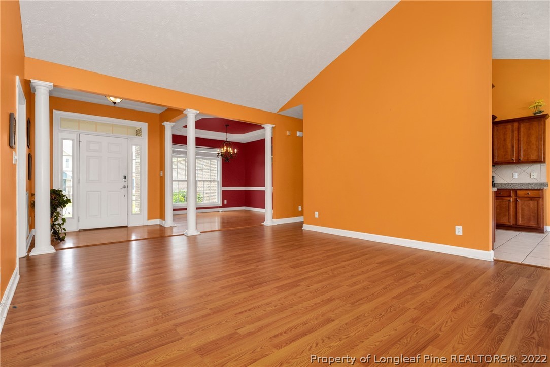 3540 Talus Road Fayetteville, NC 28306 - Photo 5 of 28 a view of an empty room with wooden floor and a window