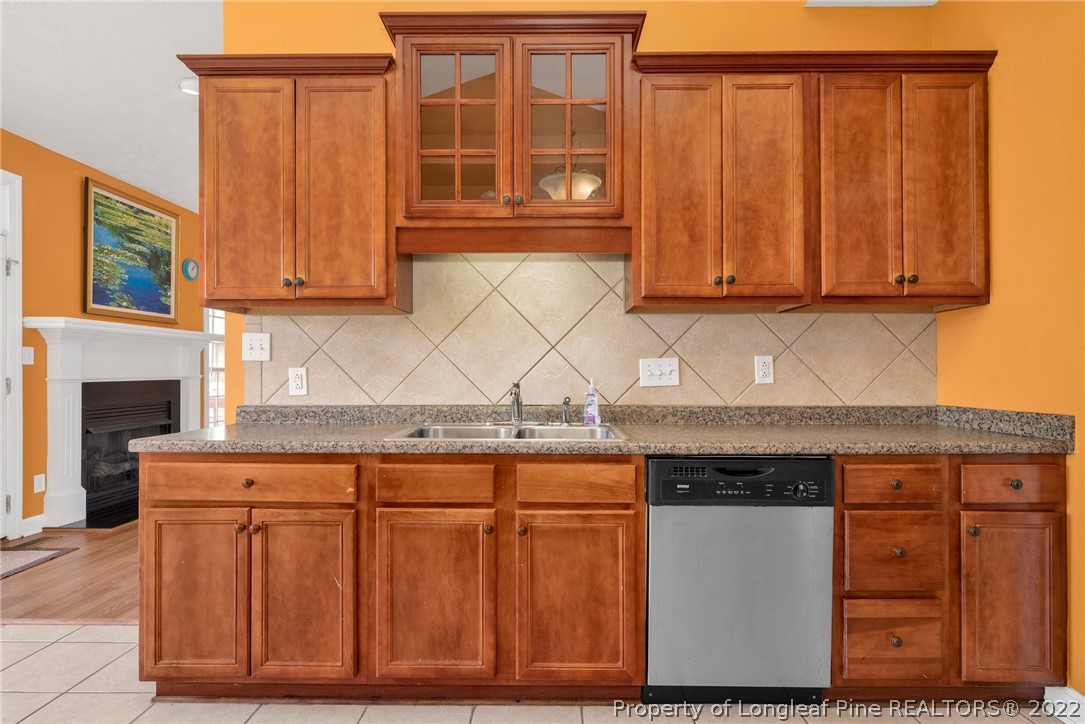3540 Talus Road Fayetteville, NC 28306 - Photo 10 of 28 a kitchen with granite countertop wooden cabinets a sink and dishwasher