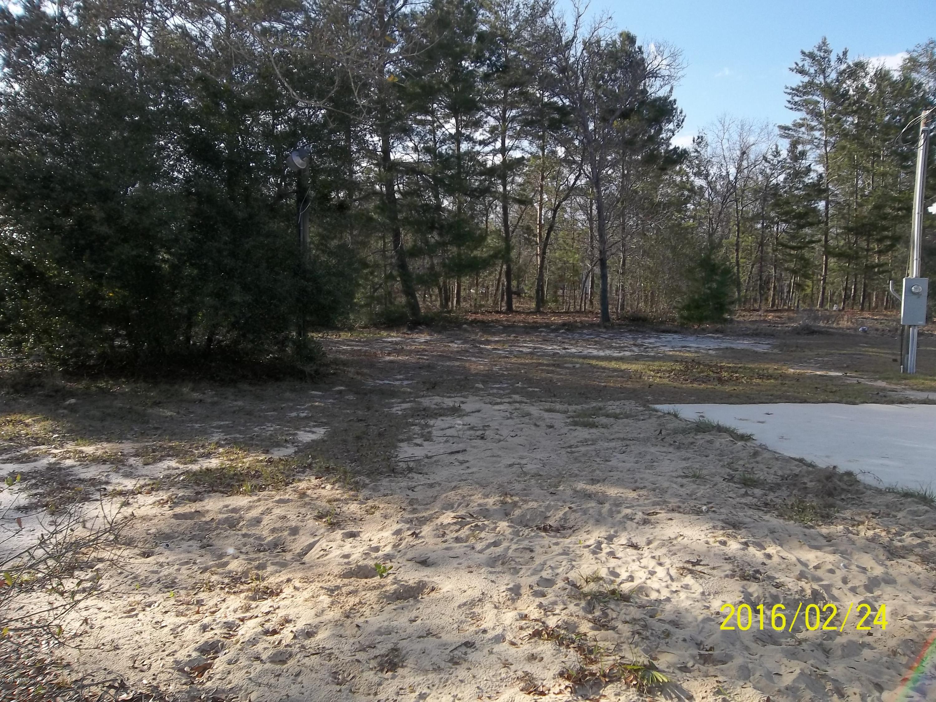 7021 Deer Springs Road Keystone Heights, FL 32656 - Photo 5 of 12 a view of a yard with a trees