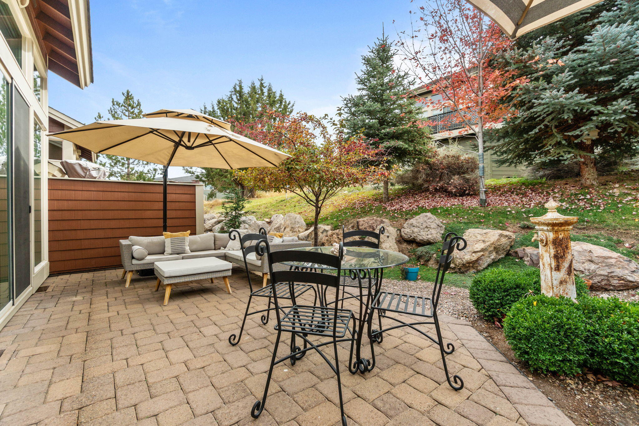 10942 Village Loop Redmond, OR 97756 - Photo 11 of 45 a view of a patio with a table and chairs under an umbrella