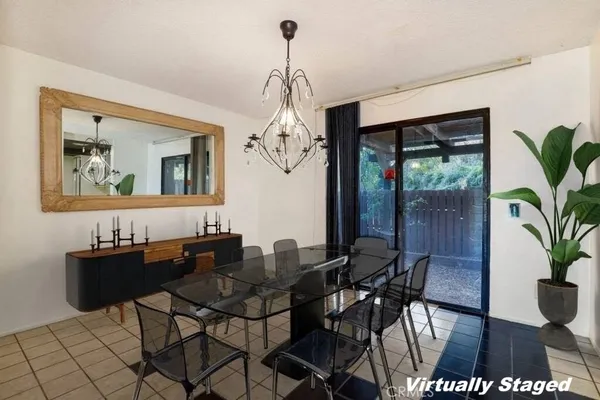 a dining room with furniture a chandelier and wooden floor