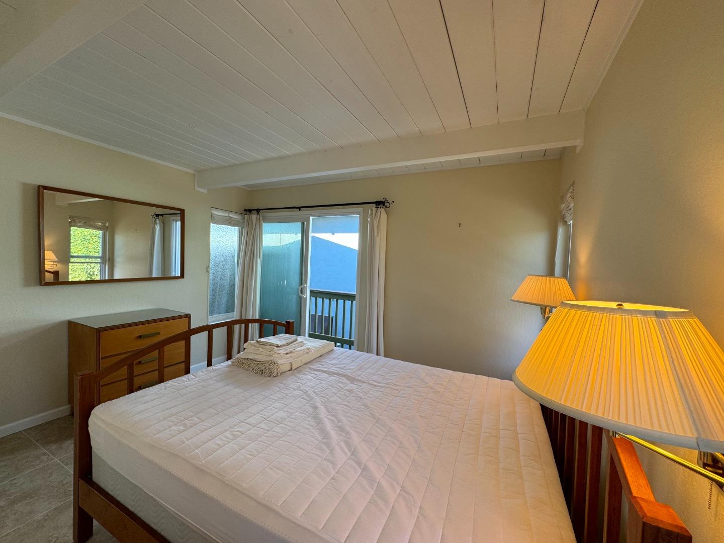 106 Winfield Way Aptos, CA 95003 - Photo 35 of 47 a bedroom with a bed and wooden floor