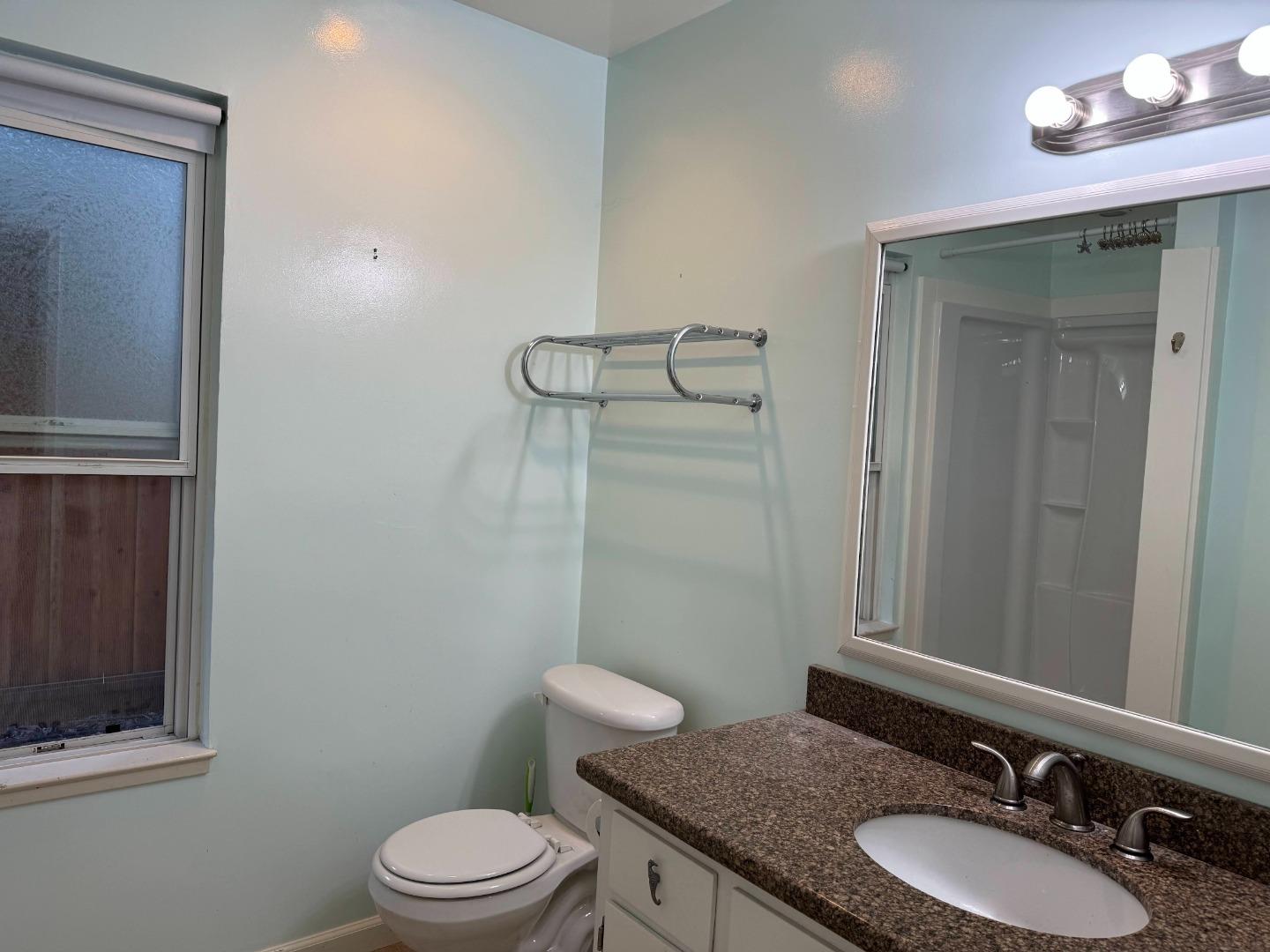 106 Winfield Way Aptos, CA 95003 - Photo 6 of 47 a bathroom with a granite countertop sink toilet a mirror and shower